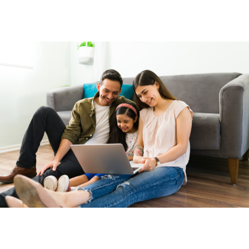 Parents or guardians with child working on computer together